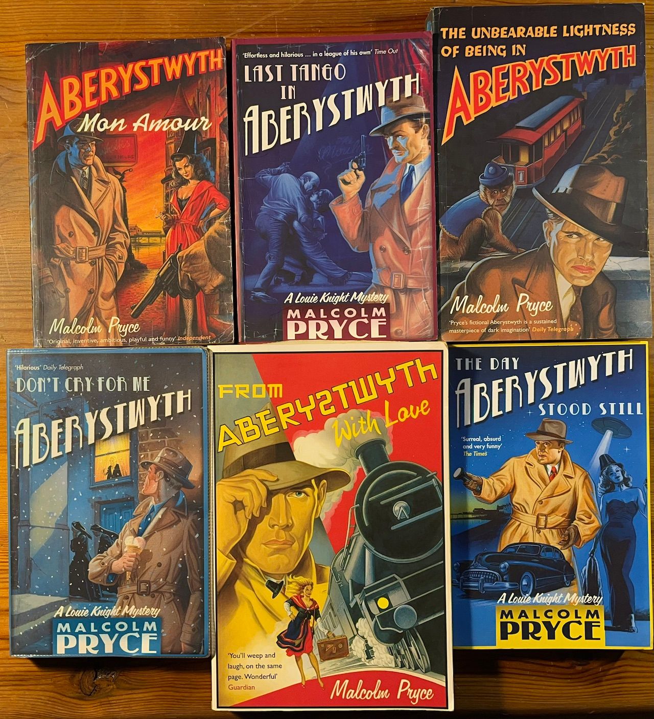 Covers of the six Aberystwyth Noir novels by Malcolm Price. Aberystwyth, Mon Amour; Last Tango in Aberystwyth; The Unbearable Lightness of Being in Aberystwyth; Don't Cry for Me, Aberystwyth; From Aberystwyth with Love; The Day Aberystwyth Stood Still