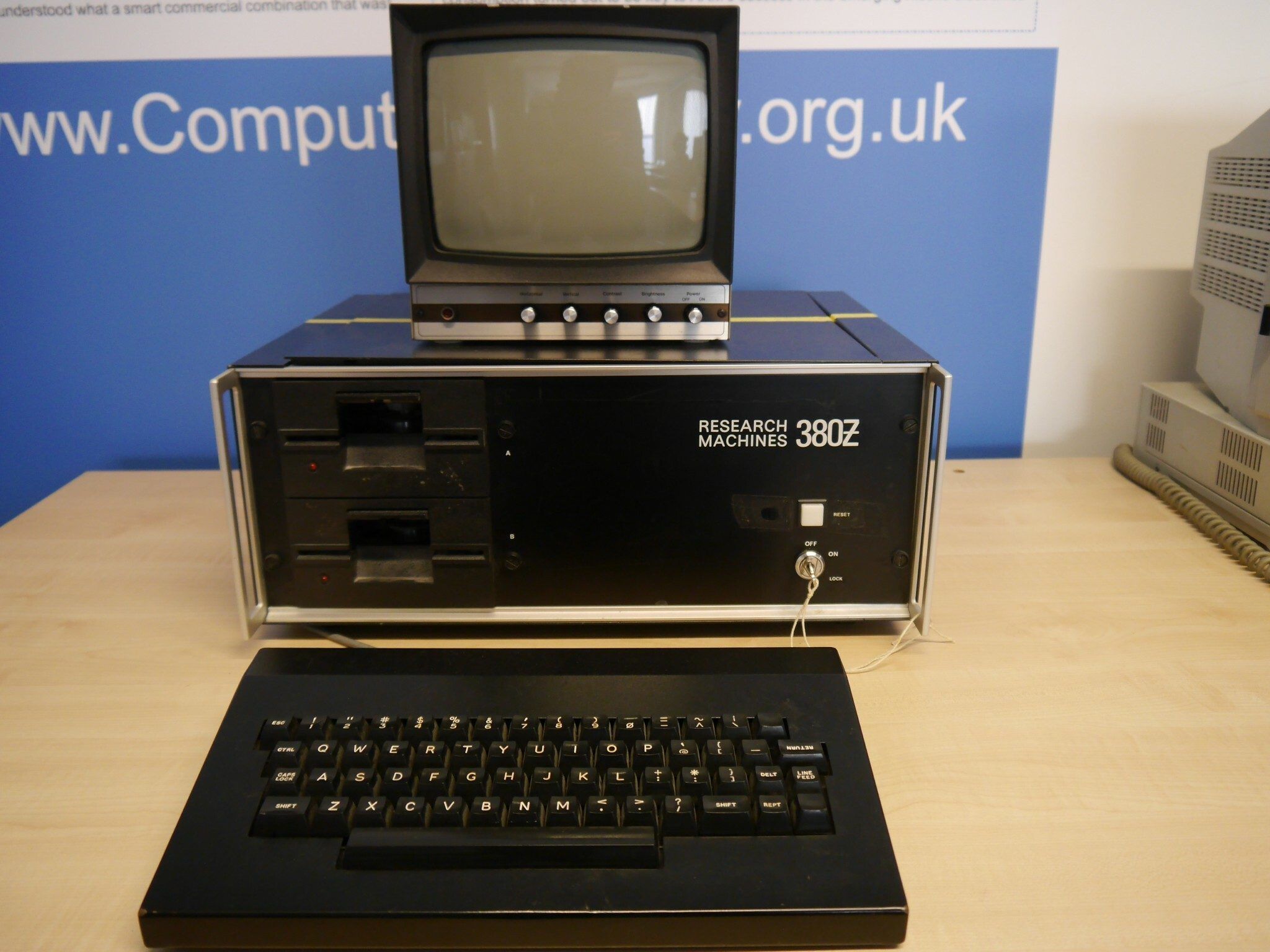 Picture of an RML 380-Z, a black metal box about the size of
a bread bin, with a key to turn it on and a lit-up reset button. The picture
also shows its boxy, metal-shelled keybaord.
